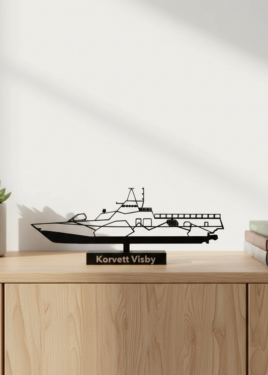 Decorative ship model on a wooden surface with a white wall background