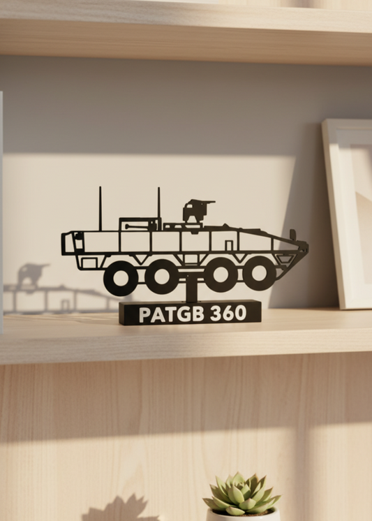 Decorative metal tank model on a shelf with books and a plant