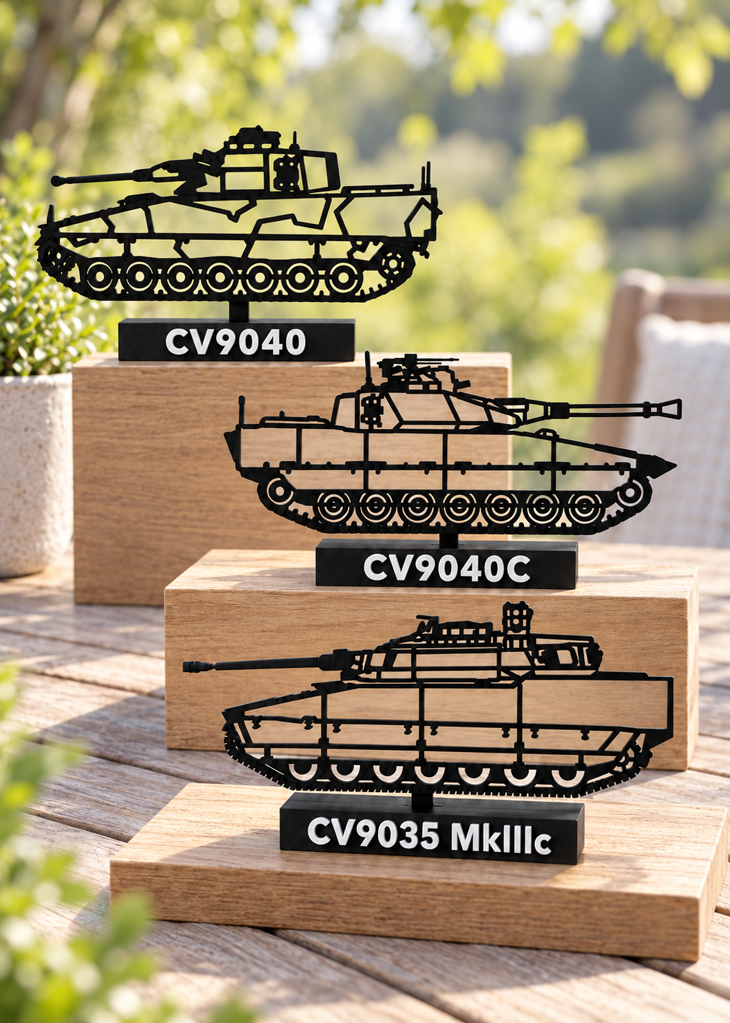 Three CV90 display silhouettes on a patio table, including updated CV9040C and CV9035 MkIII C; digital lifestyle preview.