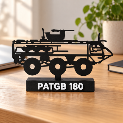 Lifestyle preview of the Swedish PATGB 180 silhouette display model on a wooden home-office desk, with its labelled black display base.