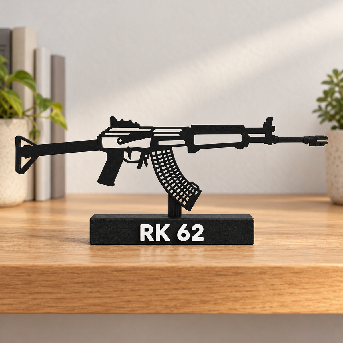 Digital lifestyle preview on an oak shelf of the updated RK 62 decorative silhouette model, with reinforced open detail lines, matte black finish and labelled display base.